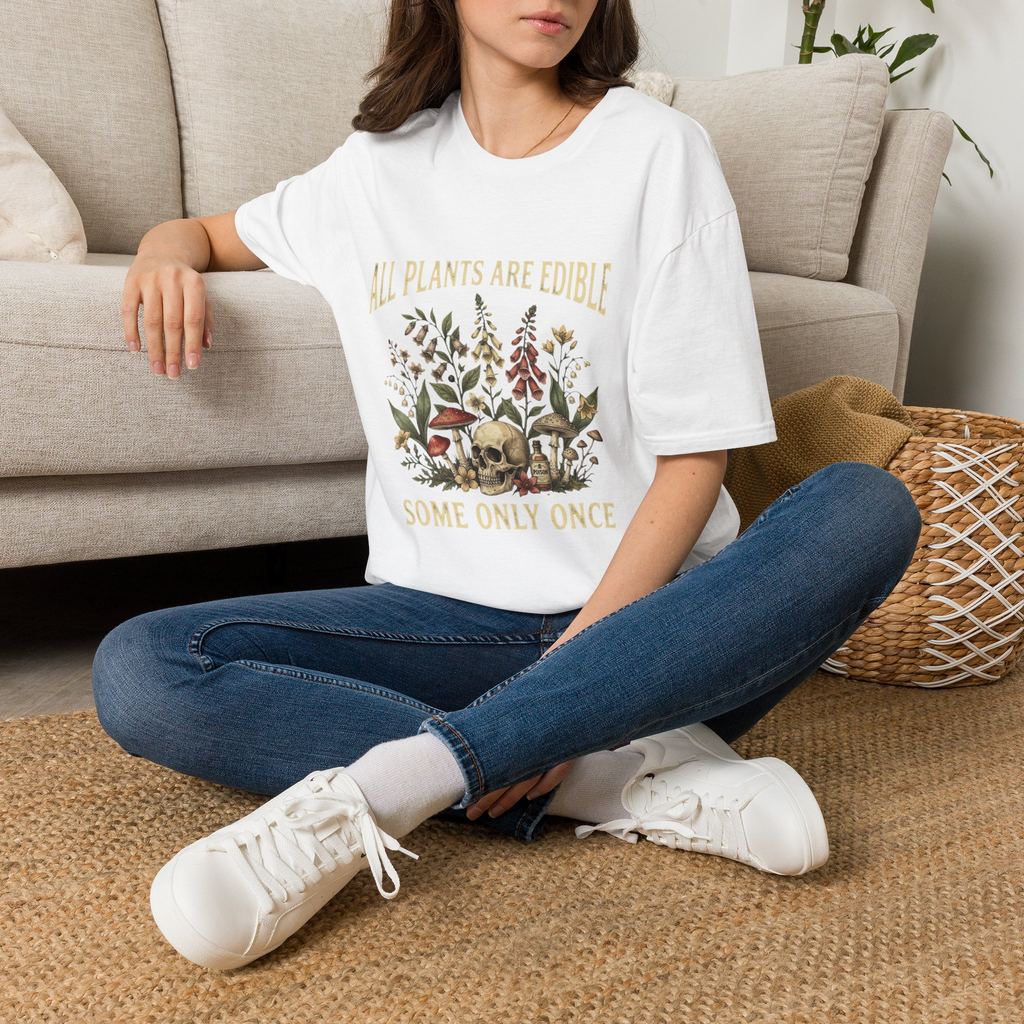 Woman wearing the All Plants Are Edible Some Only Once graphic T-shirt in white