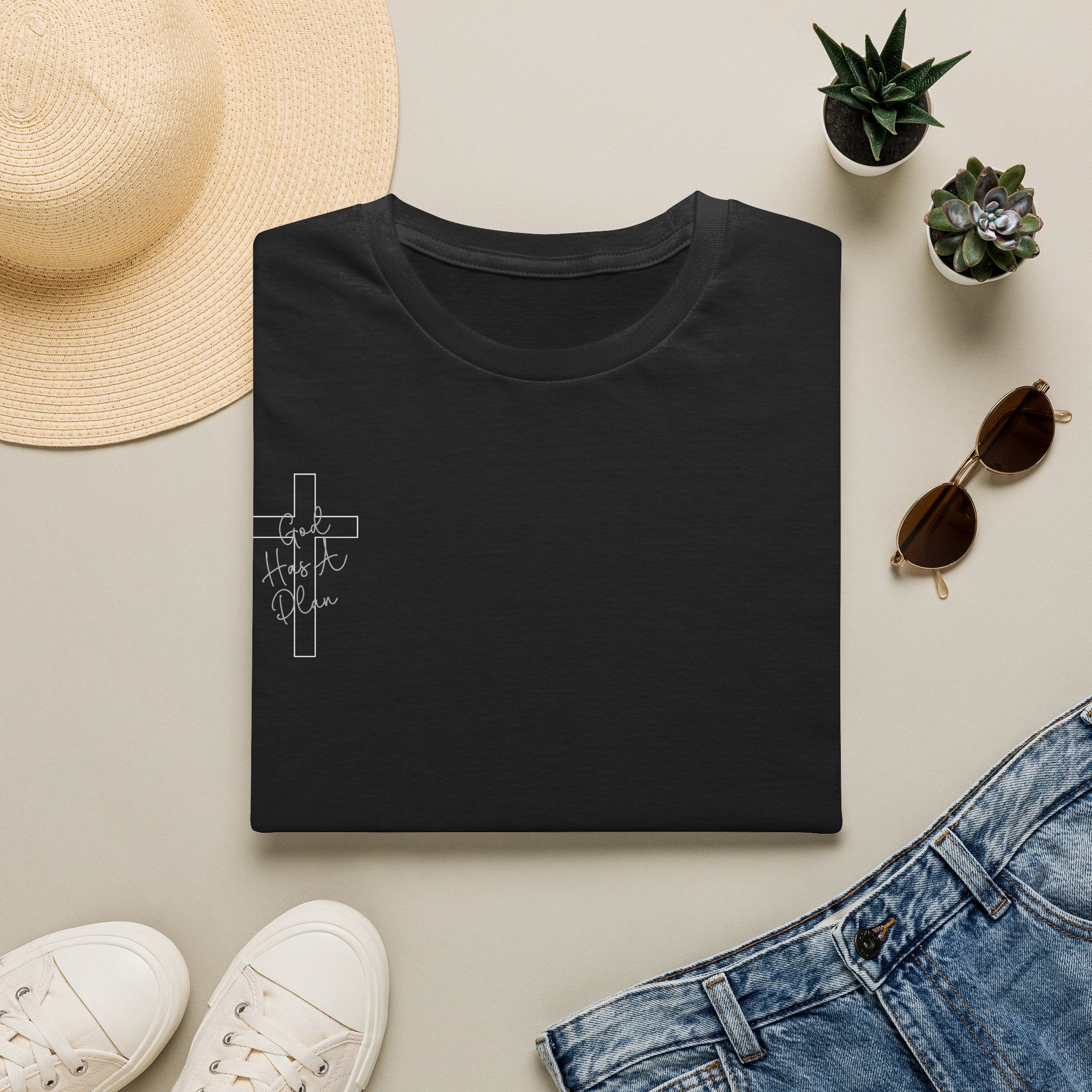 Folded black God Has a Plan Christian T-shirt showing the cross chest design